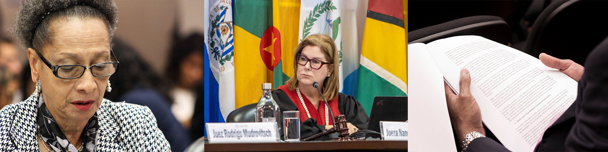 Foto de la sala de sesiones con el estrado vacío y banderas al fondo